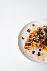 Croffle (a compound word of croissant and waffle) is a dessert where croissant raw paper is baked in a waffle pan and eaten with ice cream or maple syrup