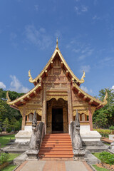 Fototapeta na wymiar Beautiful front view of historic viharn Lai Kham inside compound of famous landmark Wat Phra Singh buddhist temple, Chiang Mai, Thailand