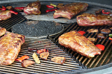 Large cuts of grilled meat with vegetables