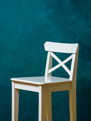 White bar stool and photophone on green canvas