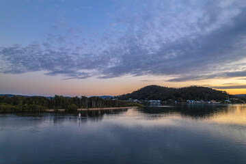 Sunrise aerial waterscape over the bay with cloud cover