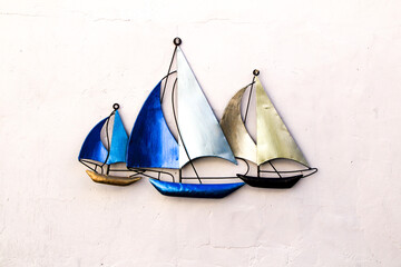 Decorative boats on a white wall