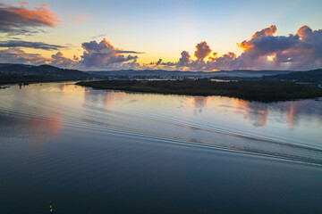 Aerial sunrise over the bay with clouds and reflections