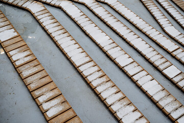 The first snow lies on a wooden bench. Urban environment park, a place where people sit. the concept of minimalism in architecture
