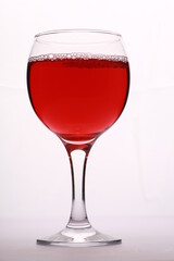 a glass of red wine on a white background close-up