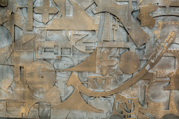 Iron background made of metal parts. The remains and scraps from industrial works are abstractly stacked. Unusual design for the use of unnecessary waste. Old rusty metal.