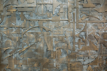 Iron background made of metal parts. The remains and scraps from industrial works are abstractly stacked. Unusual design for the use of unnecessary waste. Old rusty metal.