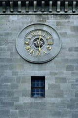 antique stone clock tower in gold color