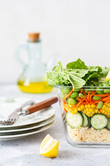 Glass box with fresh raw vegetable salad. Healthy Meal recipe preparation. Healthy vegan dishes in glass container. Vegetarian cuisine. Plant-based dishes. Green living concept. Organic food.