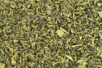 Dried green tea leaves background