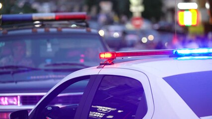 Flashing lights on a police car in a big city