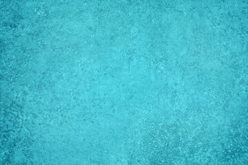 Turquoise blue plaster texture. Textured wall cyan color backdrop. Rough pastel teal painted...