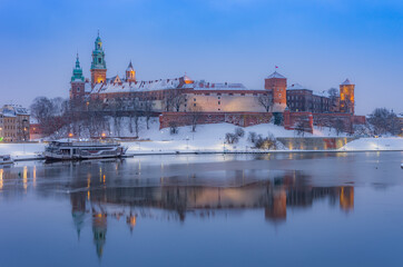 Naklejka na ściany i meble Krakow winter, night Wawel Castle over Vistula river, snow, Poland