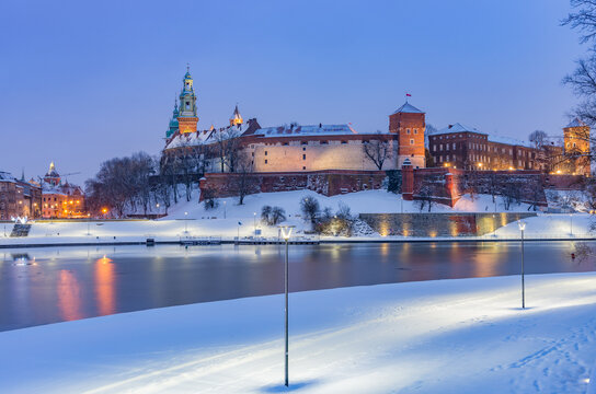 Krakow winter, night Wawel Castle over Vistula river, snow, Poland © tomeyk