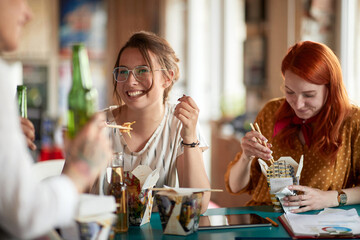 Group of young employees eating together