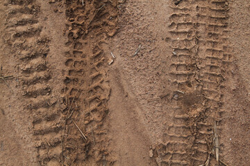 Close up of tire tracks in the sand, sand texture with tire imprints 