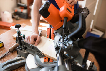 Equipment in a carpentry workshop. carpentry sawing with a circular saw for wood. workshop at home....