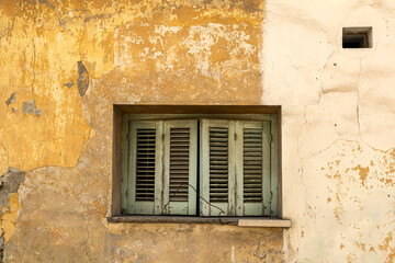 Old stucco house wall with window