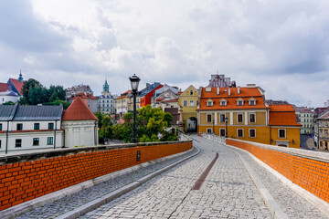 cobblestone street and bridge leading to the city gate and old town center of historic Lublin