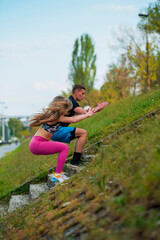 Attractive healthy fitness couple running at the stadium