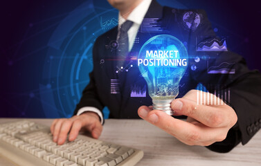 Businessman holding a light bulb, new business concept