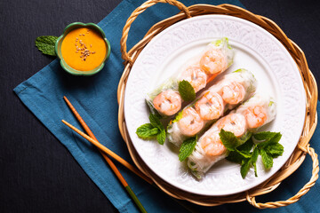Food concept Asian food homemade prawn Vietnamese rice paper spring roll and peanut dipping sauce with copy space