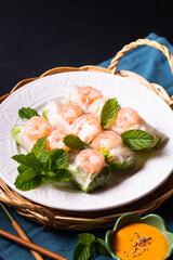 Food concept Asian food homemade prawn Vietnamese rice paper spring roll and peanut dipping sauce with copy space