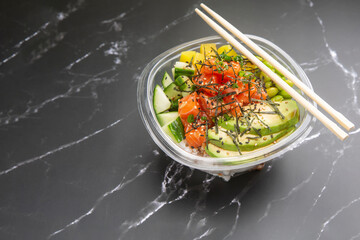 Japanese poke salad take away food on black marble background