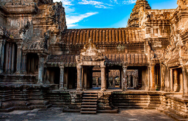 Obraz premium The ancient city of Angkor Wat in Cambodia. Towers of the temple of the Kmer people streets and ruins of houses. Traveling to the sights of ancient civilizations. Stone bas-reliefs on the ruins.
