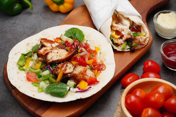  Mexican food , Chicken tortillas and wild rocket salad, spinach, topped with tomato sauce and salad cream 