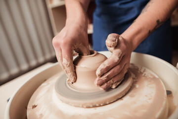 Pottery studio The process of creating pottery. The master ceramist works in her studio. workplace of potter