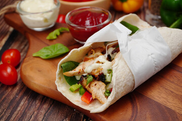  Mexican food , Chicken tortillas and wild rocket salad, spinach, topped with tomato sauce and salad cream 