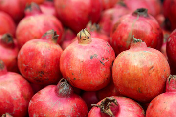 Fototapeta na wymiar Pomegranate fruits in heap at market