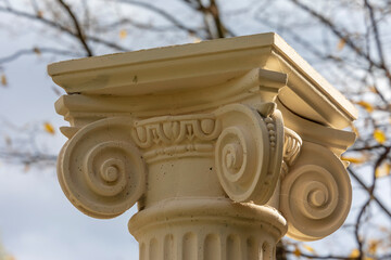 The antique concrete column is painted in beige