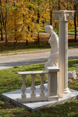 Antique sculptural composition with a woman and a column