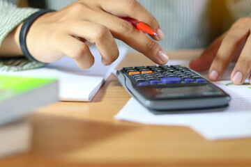 close up hand man doing finance and calculate about cost.
