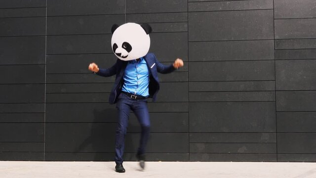 Storytelling video of a businessman wearing a giant panda mask. 