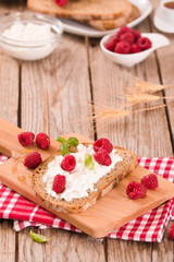 Obraz na płótnie Canvas Rye bread with cottage cheese and raspberries.