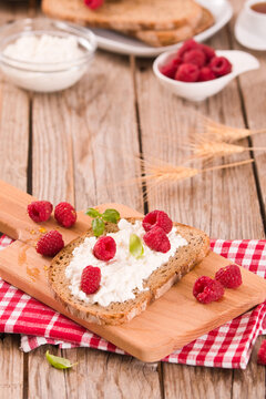 Rye bread with cottage cheese and raspberries.