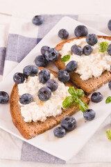 Rye bread with cottage cheese, blueberries and honey.