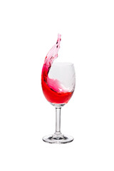 Red wine splash into glass on white background.