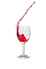 Red wine splash into glass on white background.