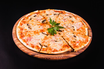 Italian pizza with mushrooms on a wooden board on a black background