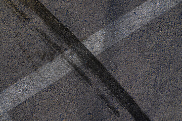 Aerial top view abstract texture and background of car tire drift skid mark on road race track, Black tire mark on street race track, Automobile and automotive concept.