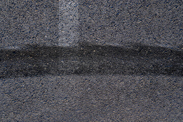 Fototapeta premium Aerial top view abstract texture and background of car tire drift skid mark on road race track, Black tire mark on street race track, Automobile and automotive concept.