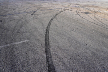 Aerial top view abstract texture and background of car tire drift skid mark on road race track, Black tire mark on street race track, Automobile and automotive concept.