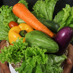 Assorted organic vegetables in wicker basket