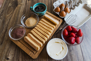 breakfast with bread and milk. Cold espresso, coffee in a cup, biscuits on a wooden board and cream...