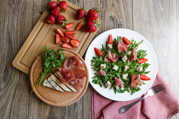 Diet summer strDiet summer strawberry salad with arugula on the table. awberry salad with arugula on the table. 