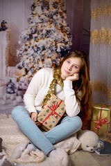 Christmas Child , Happy girl sitting front of Xmas Tree with gifts